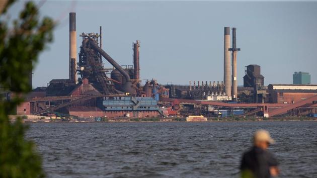People fish on Hamilton Harbour near steel mills in Hamilton, Ontario on May 31 on the eve of tariffs being imposed on the Canadian industry by the Trump administration.(AFP Photo) People fish on Hamilton Harbour near steel mills in Hamilton, Ontario on May 31 on the eve of tariffs being imposed on the Canadian industry by the Trump administration.(AFP Photo)