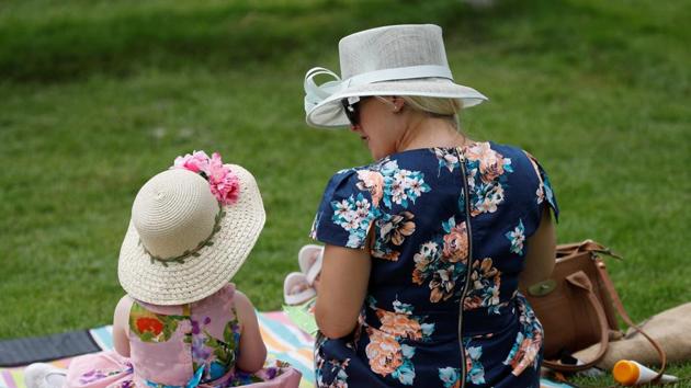 Dressing for the weather, many opted for bright and vibrant colours with pink proving to be a popular pick. (Peter Nicholls / REUTERS) Dressing for the weather, many opted for bright and vibrant colours with pink proving to be a popular pick. (Peter Nicholls / REUTERS)