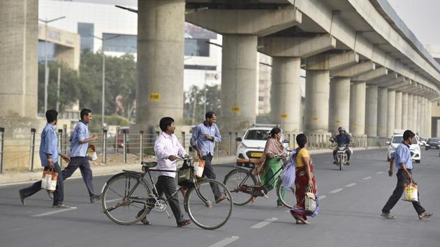 Pedestrians crossing a busy Golf Course Road, in Gurugram, India. (HT File Photo) Pedestrians crossing a busy Golf Course Road, in Gurugram, India. (HT File Photo)