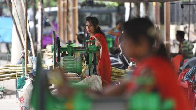 These women from Tonk manage all the chores themselves, which includes operation of the electricity-run juice machine, cleaning the utensils and delivering the juice to the customers. On an every day basis, there are about 20-25 such juice stalls in Kota’s Nayapura area, which run from around 8am-12am daily. (Raj K Raj / HT Photo) 