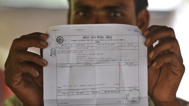 Hari Ram Meena, a sugarcane juice seller displays a permit slip issued to him by the Kota Municipal Corporation. Most of these sellers are members of the Meena community, who’re engaged primarily in agriculture. Permits from the municipal corporation are obtained after paying the statutory charges of Rs. 9050 levied for permission to ply their trade from the pavement located in the Nayapura, not far away from Talwandi, where Kota’s famed educational institutes are situated. (Raj K Raj / HT Photo) Hari Ram Meena, a sugarcane juice seller displays a permit slip issued to him by the Kota Municipal Corporation. Most of these sellers are members of the Meena community, who’re engaged primarily in agriculture. Permits from the municipal corporation are obtained after paying the statutory charges of Rs. 9050 levied for permission to ply their trade from the pavement located in the Nayapura, not far away from Talwandi, where Kota’s famed educational institutes are situated. (Raj K Raj / HT Photo)