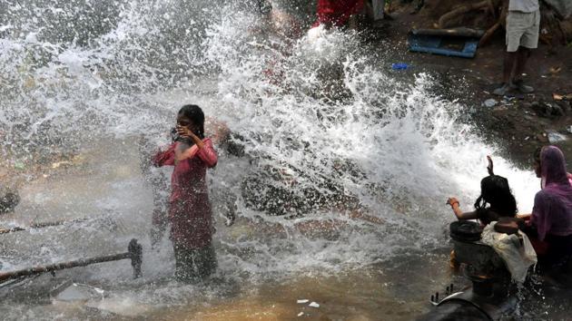 Children play in the water gushing out of a broken water supply pipeline at sector 27/42 chowk in Gurugram. Other districts of Haryana such as Hisar, Fatehabad, Jind and Panchkula have also reported a massive rain deficit. Worst hit is Hisar, which is reeling under a 83% rain deficit. (HT Photo) Children play in the water gushing out of a broken water supply pipeline at sector 27/42 chowk in Gurugram. Other districts of Haryana such as Hisar, Fatehabad, Jind and Panchkula have also reported a massive rain deficit. Worst hit is Hisar, which is reeling under a 83% rain deficit. (HT Photo)