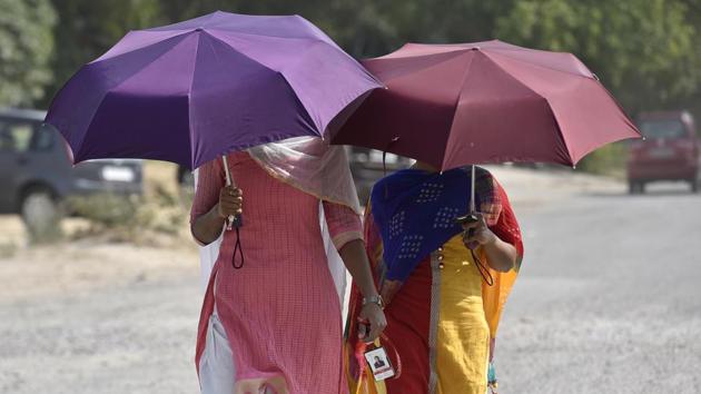 Umbrellas are out early in the city, and not to shield people from the rain, but from piercing heat that north India is facing this summer. (Sanjeev Verma / HT Photo) Umbrellas are out early in the city, and not to shield people from the rain, but from piercing heat that north India is facing this summer. (Sanjeev Verma / HT Photo)