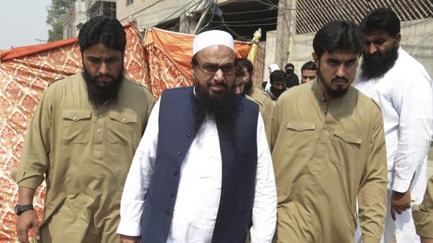 Hafiz Saeed, center, head of the Pakistani religious party Jamaat-ud-Dawa , arrives to addresses a rally in Lahore.(AP File Photo)