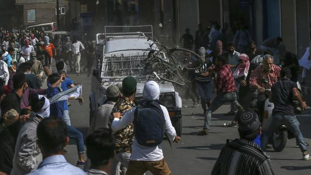 Protesters throw rocks, bricks and a cycle on a CRPF jeep in Srinagar on June 1, 2018. Two people were injured after the vehicle ran over them.(AP)