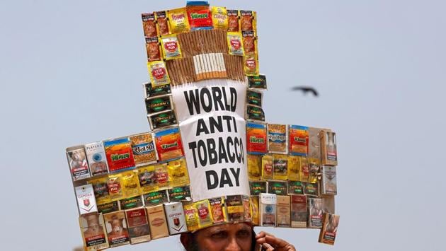 Rajendra Kumar Tiwari, a social activist, wearing a headgear made from empty cigarettes packets speaks on his mobile phone as he conducts an anti-tobacco awareness campaign to mark ‘World No Tobacco Day’ in Mumbai,Maharashtra on May 31, 2018. (Francis Mascarenhas / REUTERS) Rajendra Kumar Tiwari, a social activist, wearing a headgear made from empty cigarettes packets speaks on his mobile phone as he conducts an anti-tobacco awareness campaign to mark ‘World No Tobacco Day’ in Mumbai,Maharashtra on May 31, 2018. (Francis Mascarenhas / REUTERS)