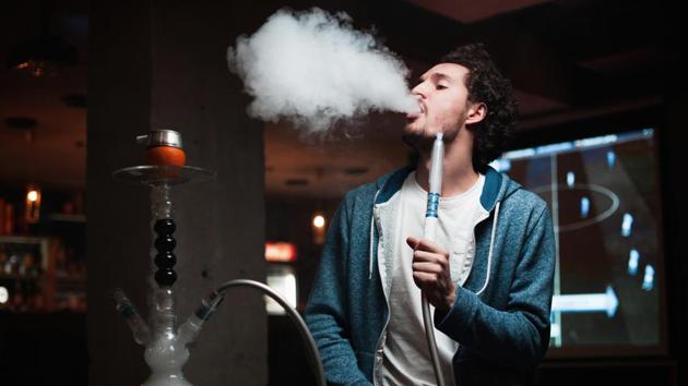 Hookah is used to smoke tobacco in an intricate set-up, where the heated tobacco smoke passes through cool water to reach the smoker via a water pipe structure.(Shutterstock)