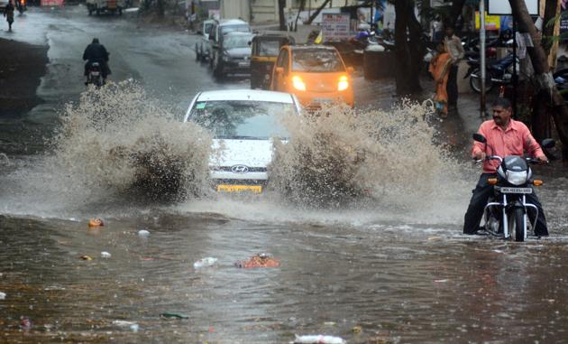 Motorists make their way through a waterlogged area at Rakshaknagar, Kharadi, on Saturday. The road is riddled with potholes and is in the vicinity of several residential societies and residents have to commute through these puddles; Pedestrians cross the road in a hurry during heavy rainfall at Chandani chowk on Saturday. Traffic jams were witnessed at multiple places across the city, including Sinhagad road. Several commuters were left stranded for hours on the streets. (SHANKAR NARAYAN/ ht photo ) Motorists make their way through a waterlogged area at Rakshaknagar, Kharadi, on Saturday. The road is riddled with potholes and is in the vicinity of several residential societies and residents have to commute through these puddles; Pedestrians cross the road in a hurry during heavy rainfall at Chandani chowk on Saturday. Traffic jams were witnessed at multiple places across the city, including Sinhagad road. Several commuters were left stranded for hours on the streets. (SHANKAR NARAYAN/ ht photo )