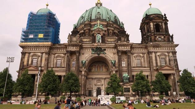People sit in front of the Berliner Dom after a German policeman shot a man at the Berlin Cathedral. (Reuters Photo) People sit in front of the Berliner Dom after a German policeman shot a man at the Berlin Cathedral. (Reuters Photo)