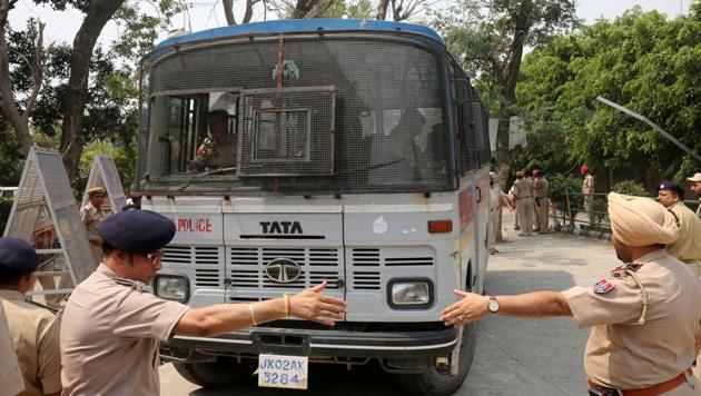 Police officers gesture as a vehicle carrying accused in the rape and murder of an eight-year-old girl in Kathua, near Jammu, enters a court premises in Pathankot, Punjab, on May 31, 2018.(Reuters File Photo) Police officers gesture as a vehicle carrying accused in the rape and murder of an eight-year-old girl in Kathua, near Jammu, enters a court premises in Pathankot, Punjab, on May 31, 2018.(Reuters File Photo)