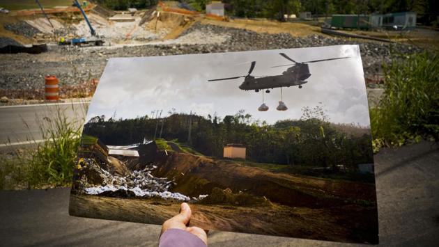 An image of a US army helicopter transporting material to repair the damaged Guajataca Dam during the hurricane is seen in at the same location as repairs continue. The Federal Emergency Management Agency (FEMA) distributed 59,000 plastic sheets to homeowners who lost their roofs to Irma or Maria. But only 21,000 households have so far received federal aid to carry out permanent repairs. (Ramon Espinosa / AP)