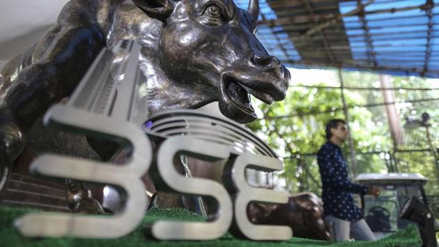 The Bombay Stock Exchange (BSE) logo is displayed in front of a bronze bull statue at the Bombay Stock Exchange in Mumbai.(Dhiraj Singh/Bloomberg)
