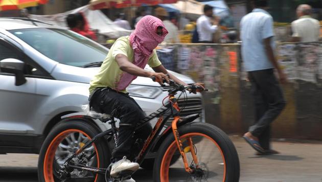 A cyclist covers his face with towel to protect from the heat while riding along a major road on a hot day near Mahveer Chowk, in Gurugram, India on Monday, 04 June 2018. (HT Photo) A cyclist covers his face with towel to protect from the heat while riding along a major road on a hot day near Mahveer Chowk, in Gurugram, India on Monday, 04 June 2018. (HT Photo)