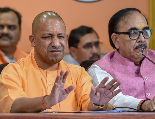 Uttar Pradesh chief minister Yogi Adityanath refused to take a gold chain with rudraksha beads offered as a gift by party MLA, Ravindra Nath Tripathi at a public function in Bhadohi on Sunday.(PTI)