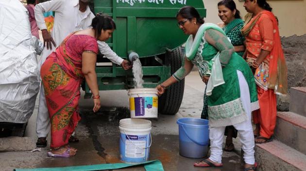 Residents filling water in buckets from a water tanker in Gurgaon. (HT File Photo) Residents filling water in buckets from a water tanker in Gurgaon. (HT File Photo)