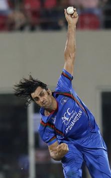 Afghanistan cricket player Shapoor Zadran bowls during the first T20 cricket match between Afghanistan and Bangladesh in Dehradun.(AP)