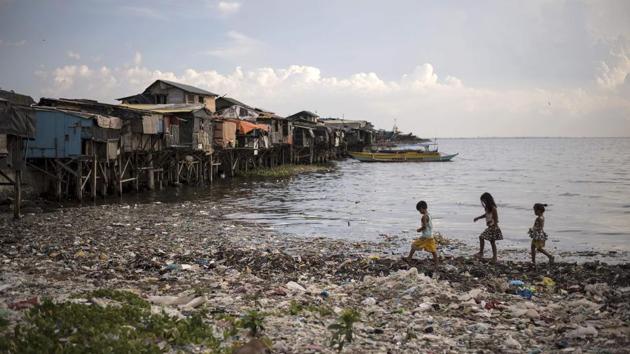 Children walk along a garbage-filled bay in Manila. According to the UN Joint Group of Experts on the Scientific Aspects of Marine Pollution, land-based sources account for up to 80% of the world’s marine pollution, 60- 90% of the waste being plastic debris.(AFP Photo)