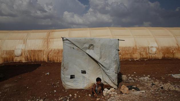 A sign at al-Bab camp gate in northern Syria reads: “Sons of the Eastern (province) welcome their brothers from eastern Ghouta.” Some 5,000 people from Ghouta arrived here in April from the east. The population of the Turkish controlled town, about 7,000 under the Islamic State rose to 300,000 as displaced Syrians sought refuge. They are now resigned to a life of exile in the north. (Lefteris Pitarakis / AP ) A sign at al-Bab camp gate in northern Syria reads: “Sons of the Eastern (province) welcome their brothers from eastern Ghouta.” Some 5,000 people from Ghouta arrived here in April from the east. The population of the Turkish controlled town, about 7,000 under the Islamic State rose to 300,000 as displaced Syrians sought refuge. They are now resigned to a life of exile in the north. (Lefteris Pitarakis / AP )