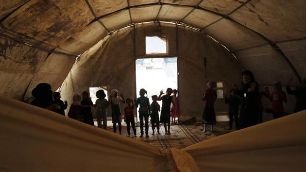 The tent is divided with sheets to create a changing room and a sleeping area for the mother and father. The grandmother and children sleep in the open area. “It is not a life really. But better than Douma,” said Maysaa, who lives with her husband, their four children and her husband’s mother. “We can at least sleep. The children can at least play outside.” (Lefteris Pitarakis / AP) The tent is divided with sheets to create a changing room and a sleeping area for the mother and father. The grandmother and children sleep in the open area. “It is not a life really. But better than Douma,” said Maysaa, who lives with her husband, their four children and her husband’s mother. “We can at least sleep. The children can at least play outside.” (Lefteris Pitarakis / AP)