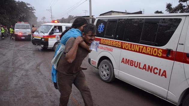 People flee from the El Rodeo village in Guatemala City after the eruption. Fifteen people, including 12 children, have been hospitalised, some of whom suffered severe burns, the health ministry said on Tuesday. The death toll stands at 69 with over 1 million residents affected. According to Guatemala’s national disaster agency, CONRED, just a fraction of the victims have been identified so far. (Noe Perez / AFP) People flee from the El Rodeo village in Guatemala City after the eruption. Fifteen people, including 12 children, have been hospitalised, some of whom suffered severe burns, the health ministry said on Tuesday. The death toll stands at 69 with over 1 million residents affected. According to Guatemala’s national disaster agency, CONRED, just a fraction of the victims have been identified so far. (Noe Perez / AFP)