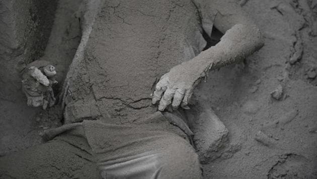 Bodies were so thickly coated with ash that they looked like statues. Rescuers were forced to use sledgehammers to break through roofs buried in debris to see if anyone was trapped inside. The task of retrieving bodies was hindered by another eruption on Monday and an apparent landslide on the southern slopes of Fuego which triggered fresh evacuations. (Johan Ordonez / AFP) Bodies were so thickly coated with ash that they looked like statues. Rescuers were forced to use sledgehammers to break through roofs buried in debris to see if anyone was trapped inside. The task of retrieving bodies was hindered by another eruption on Monday and an apparent landslide on the southern slopes of Fuego which triggered fresh evacuations. (Johan Ordonez / AFP)