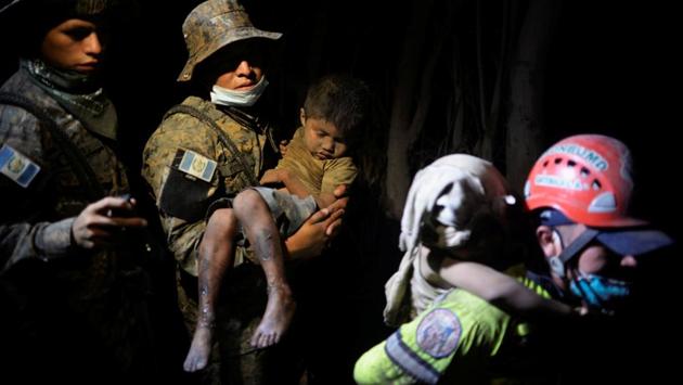 A soldier takes a rescued child covered with ash to a hospital in El Rodeo. For the family members of the victims, the process of identification has been a draining process as most bodies remain unrecognizable. “It is very difficult for us to identify them because some of the dead lost their features or their fingerprints”, said Fanuel Garcia, director of the National Institute of Forensic Sciences. (Fabricio Alonzo / REUTERS) A soldier takes a rescued child covered with ash to a hospital in El Rodeo. For the family members of the victims, the process of identification has been a draining process as most bodies remain unrecognizable. “It is very difficult for us to identify them because some of the dead lost their features or their fingerprints”, said Fanuel Garcia, director of the National Institute of Forensic Sciences. (Fabricio Alonzo / REUTERS)
