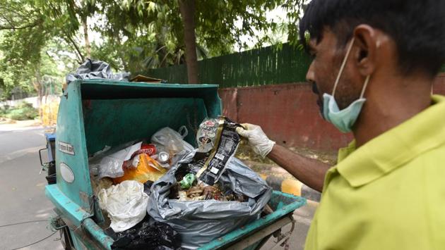 “People think we are unclean,” Hamid said, weaving through the neat lanes of Pandara road on a customised rickshaw. In the back of his customised rickshaw he sifts for anything that would fetch money in the recycling market: bottles, bags, cardboard. As he tore open a plastic trash bag collected from a house to examine its contents, he remarked, “Some people are dirtier than me.” (Anushree Fadnavis / HT Photo)