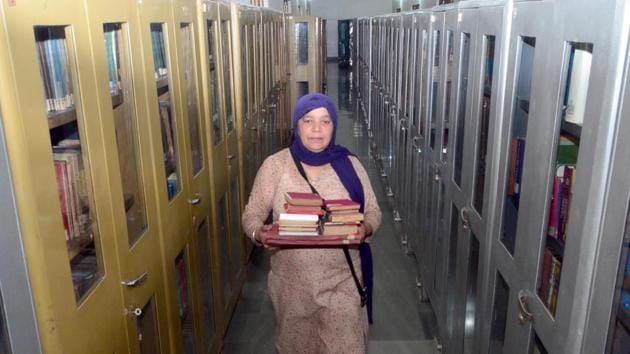An employee sorting books at Sikh Reference Library at Golden Temple in Amritsar on Tuesday.(Sameer Sehgal/HT)