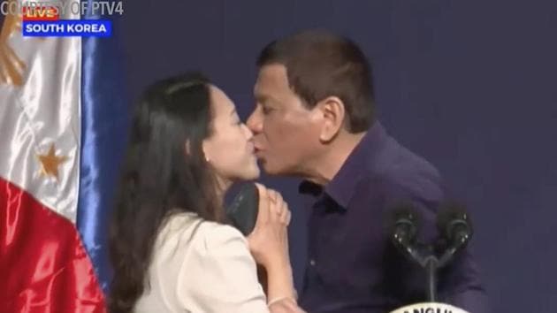 In this video grab from PTV taken on Sunday, Philippines President Rodrigo Duterte leans in to kiss a Filipino worker at the podium during a townhall-style meeting with overseas Filipino workers in Seoul, South Korea. (AP) In this video grab from PTV taken on Sunday, Philippines President Rodrigo Duterte leans in to kiss a Filipino worker at the podium during a townhall-style meeting with overseas Filipino workers in Seoul, South Korea. (AP)