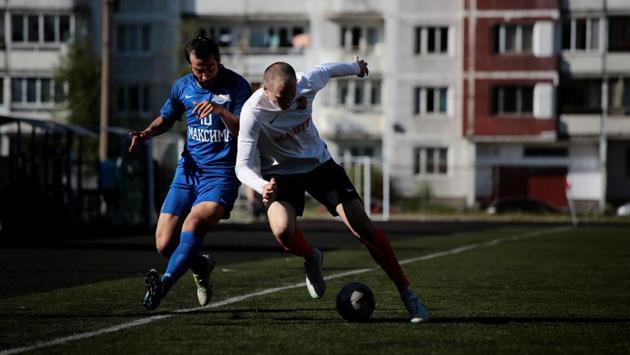 FC Maxima's Mohammed Hafez fights for the ball during their championship match. The 27-year-old is hoping to emulate the rise to fame of Egyptian Liverpool striker Mohamed Salah. “This is my dream, to play, and I will not give up, God willing I will make this come true,” Hafez said. (Anton Vaganov / REUTERS) FC Maxima's Mohammed Hafez fights for the ball during their championship match. The 27-year-old is hoping to emulate the rise to fame of Egyptian Liverpool striker Mohamed Salah. “This is my dream, to play, and I will not give up, God willing I will make this come true,” Hafez said. (Anton Vaganov / REUTERS)