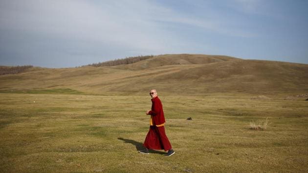 Senior Buddhist monk Lobsang Tayang walks outside the Amarbayasgalant Monastery in Mongolia. Buddhism is one of the world’s oldest religions but its fate in Mongolia now rests on young shoulders. The country’s monasteries are increasingly run by millennial monks, the first generation to come of age after decades of religious repression under the Soviet system wiped out almost all Buddhist clergy. (Thomas Peter / REUTERS) Senior Buddhist monk Lobsang Tayang walks outside the Amarbayasgalant Monastery in Mongolia. Buddhism is one of the world’s oldest religions but its fate in Mongolia now rests on young shoulders. The country’s monasteries are increasingly run by millennial monks, the first generation to come of age after decades of religious repression under the Soviet system wiped out almost all Buddhist clergy. (Thomas Peter / REUTERS)