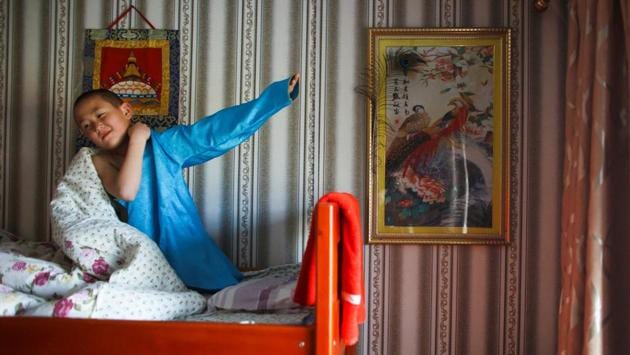 Young monk Temuulen gets dressed after waking up at in his room at the monastery. After democracy came to Mongolia in 1990, monasteries and schools were re-established by survivors, many already then in their 70s. Now fewer than 40 are left, and the oldest, the head of the monastery, is just 35. (Thomas Peter / REUTERS) Young monk Temuulen gets dressed after waking up at in his room at the monastery. After democracy came to Mongolia in 1990, monasteries and schools were re-established by survivors, many already then in their 70s. Now fewer than 40 are left, and the oldest, the head of the monastery, is just 35. (Thomas Peter / REUTERS)