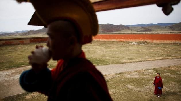 Temuulen watches a fellow monk blow a seashell as a call to prayers. Such a choice of career which involves a strict lifestyle devoid of earthly attachments is unusual in the modern world, and finding children willing to sign up can be tricky. The choice is often made as much by parents as their children, and is rarely a straightforward task. (Thomas Peter / REUTERS) Temuulen watches a fellow monk blow a seashell as a call to prayers. Such a choice of career which involves a strict lifestyle devoid of earthly attachments is unusual in the modern world, and finding children willing to sign up can be tricky. The choice is often made as much by parents as their children, and is rarely a straightforward task. (Thomas Peter / REUTERS)