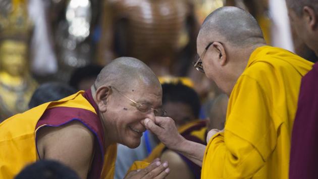 Tibetan spiritual leader the Dalai Lama playfully pinches the nose of a senior monk as he arrives to give a talk to Tibetan youth in Dharmsala. Every year the Tibetan leader speaks to young Tibetans to introduce them to Buddhist precepts. (Ashwini Bhatia / AP)