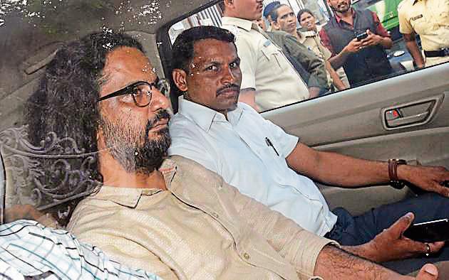 Rona Wilson (left), arrested due to alleged Maoist links in the Bhima Koregaon violence, was produced in court in Pune on Thursday.(Pratham Gokhale/HT Photo)