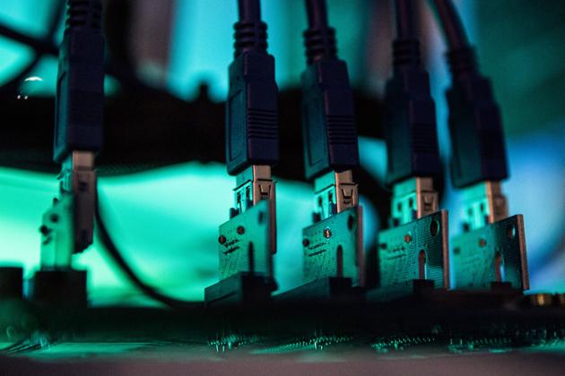 Lights illuminate USB cables inside a 'mining rig' computer, used to mine cryptocurrency, in Budapest. (Akos Stiller/Bloomberg) Lights illuminate USB cables inside a 'mining rig' computer, used to mine cryptocurrency, in Budapest. (Akos Stiller/Bloomberg)