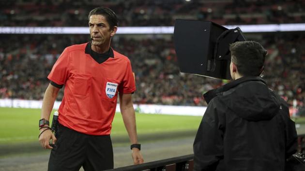 Referee Deniz Aytekin consults the VAR (video assistant referee) before awarding a penalty to Italy during the international friendly soccer match between England and Italy at the Wembley Stadium in London, Tuesday, March 27, 2018. (Nick Potts/PA via AP)(AP)