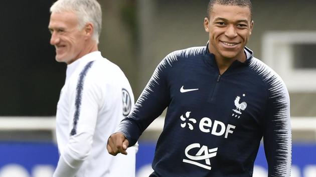France's head coach Didier Deschamps (L) and French forward Kylian Mbappe (R) take part in a training session. (AFP) France's head coach Didier Deschamps (L) and French forward Kylian Mbappe (R) take part in a training session. (AFP)