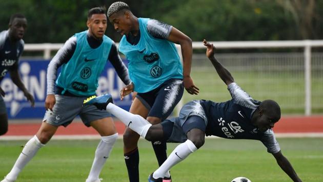 French defender Presnel Kimpembe (C) and French midfielder N'Golo Kante (R) vie for the ball in training. (AFP) French defender Presnel Kimpembe (C) and French midfielder N'Golo Kante (R) vie for the ball in training. (AFP)
