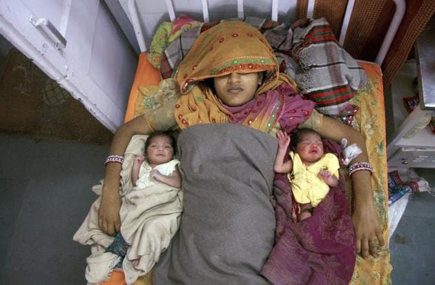 A mother with her twin daughters at a government hospital in Ganganagar.(HT File Photo/Representative Photo)
