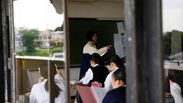 A teacher wearing traditional Korean clothes teaches English to her students at Kanagawa Korean Middle and High School. “I thought reunification was something in the distant future, especially with all the sanctions” on the North, said 17-year-old Paeng Yu Na, who attends one of about 60 schools across Japan affiliated with the North. (Kim Kyung-Hoon / REUTERS) A teacher wearing traditional Korean clothes teaches English to her students at Kanagawa Korean Middle and High School. “I thought reunification was something in the distant future, especially with all the sanctions” on the North, said 17-year-old Paeng Yu Na, who attends one of about 60 schools across Japan affiliated with the North. (Kim Kyung-Hoon / REUTERS)