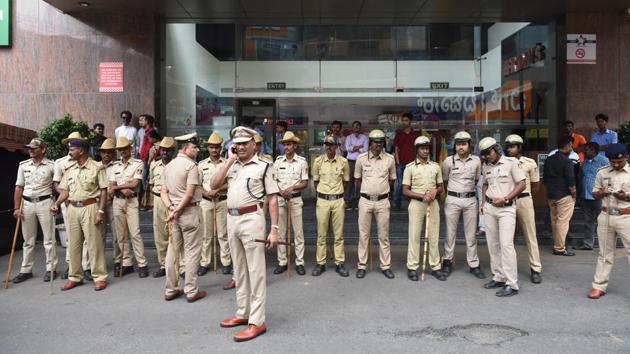 Police stands guard outside Lido Mall in Bengaluru. Widespread protests by pro-Kannada activists marred the screening of the Rajinikanth-starrer ‘Kaala’ in most parts of the state on Thursday. Agitators were seen requesting the 67-year-old actor’s fans not to watch the movie for the sake of their Kannada brethren fighting for Cauvery water. (Arijit Sen / HT Photo)