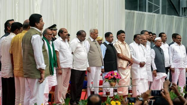 Karnataka governor Vajubhai Vala, chief minister HD Kumaraswamy, deputy chief minister G Parameshwara with newly inducted ministers during the first expansion of the JD(S) and Congress coalition government, at Rajbhavan in Bengaluru on Wednesday. (PTI Photo) Karnataka governor Vajubhai Vala, chief minister HD Kumaraswamy, deputy chief minister G Parameshwara with newly inducted ministers during the first expansion of the JD(S) and Congress coalition government, at Rajbhavan in Bengaluru on Wednesday. (PTI Photo)