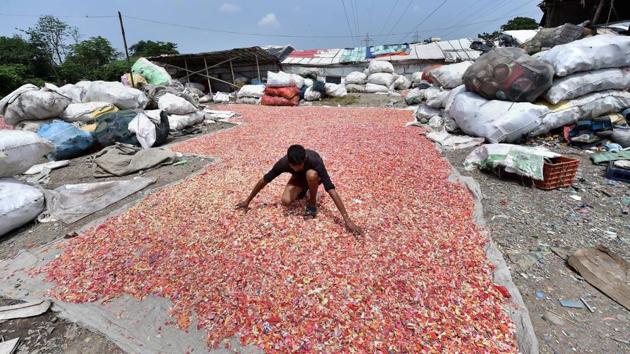 A worker lays out plastic pieces for drying ahead of recycling them, in Kolkata, West Bengal, on June 05, 2018. (Swapan Mahapatra / PTI) A worker lays out plastic pieces for drying ahead of recycling them, in Kolkata, West Bengal, on June 05, 2018. (Swapan Mahapatra / PTI)