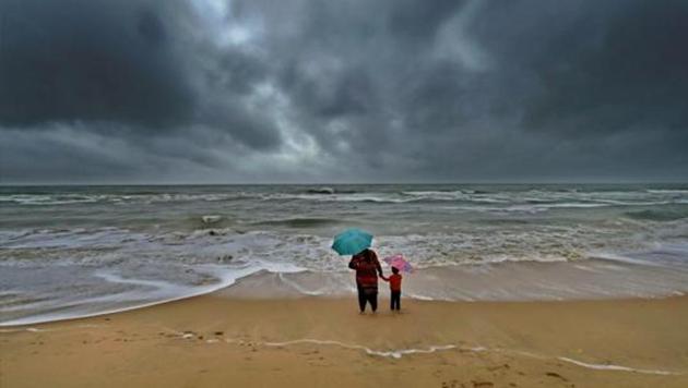 A woman standing with her son at Marina beach following heavy downpour in Chennai. (PTI Representative Photo) A woman standing with her son at Marina beach following heavy downpour in Chennai. (PTI Representative Photo)