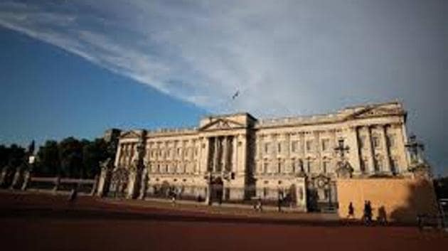 People walk past a protective board outside Buckingham Palace in London, Britain. (Reuters File Photo) People walk past a protective board outside Buckingham Palace in London, Britain. (Reuters File Photo)