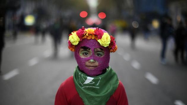 A little girl takes part in a march called by the movement “Ni una menos” (Not One Less) against violence against women, and in demand of the right to a safe, free and legal abortion in Buenos Aires, Argentina. (Eitan Abramovich / AFP)