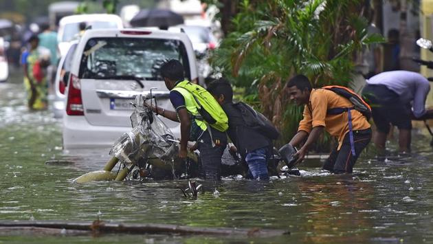 People push a motorbike through a water-logged street in Mumbai. The advisory released by the IMD read: “Active to vigorous monsoon conditions are likely to prevail, leading to persistent very heavy rainfall along the west coast, especially between June 10 and 11. In view of intense rainfall forecast, people are advised to abstain from outdoor activities as much as possible.” (Vijayanand Gupta / HT Photo) People push a motorbike through a water-logged street in Mumbai. The advisory released by the IMD read: “Active to vigorous monsoon conditions are likely to prevail, leading to persistent very heavy rainfall along the west coast, especially between June 10 and 11. In view of intense rainfall forecast, people are advised to abstain from outdoor activities as much as possible.” (Vijayanand Gupta / HT Photo)