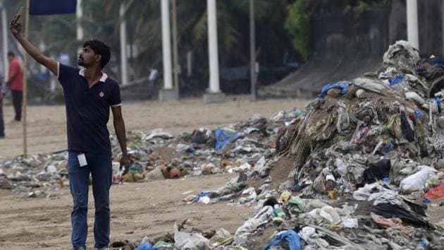 A man takes a selfie in front of a heap of garbage on the shores of the Arabian Sea in Mumbai.(AP FILE PHOTO) A man takes a selfie in front of a heap of garbage on the shores of the Arabian Sea in Mumbai.(AP FILE PHOTO)