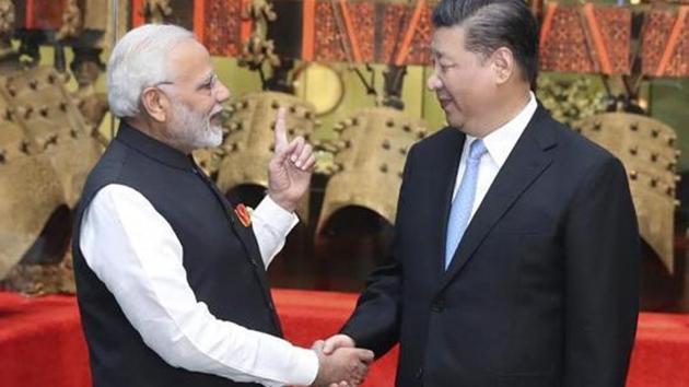 Narendra Modi shakes hands with Chinese President Xi Jinping as they visit an exhibition of cultural relics at the Hubei Provincial Museum in Wuhan in central China's Hubei Province, April 27, 2018.(AP File Photo)